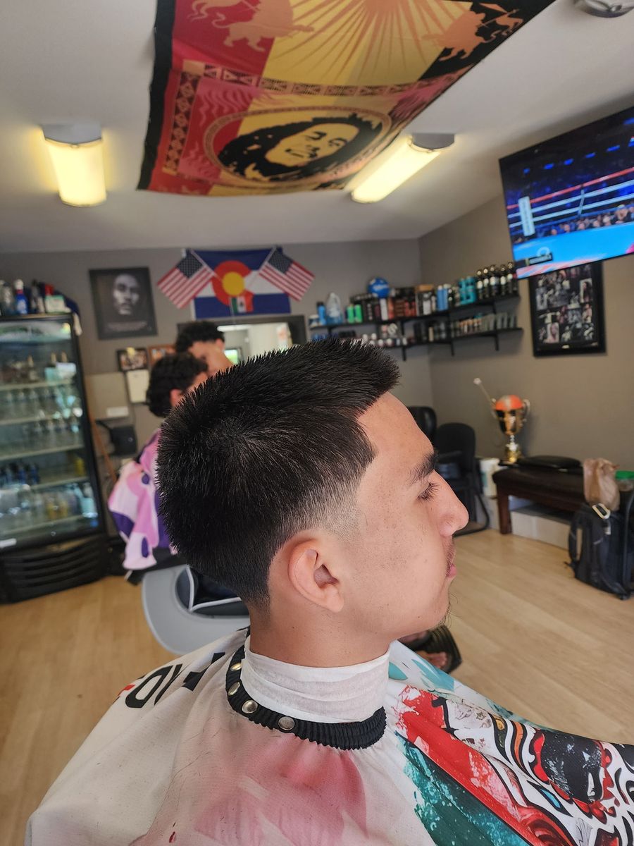 A sharp taper fade cut at Champ's Barber Shop