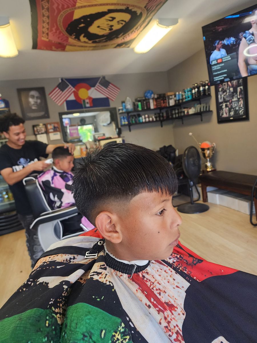 A kid's haircut finished at Champ's Barber Shop