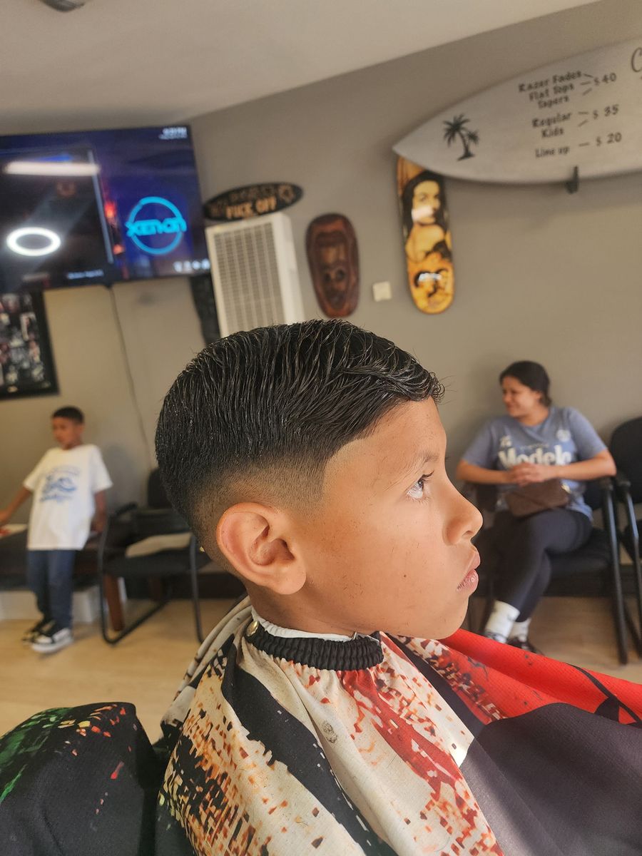A clean kid's fade finished at the shop